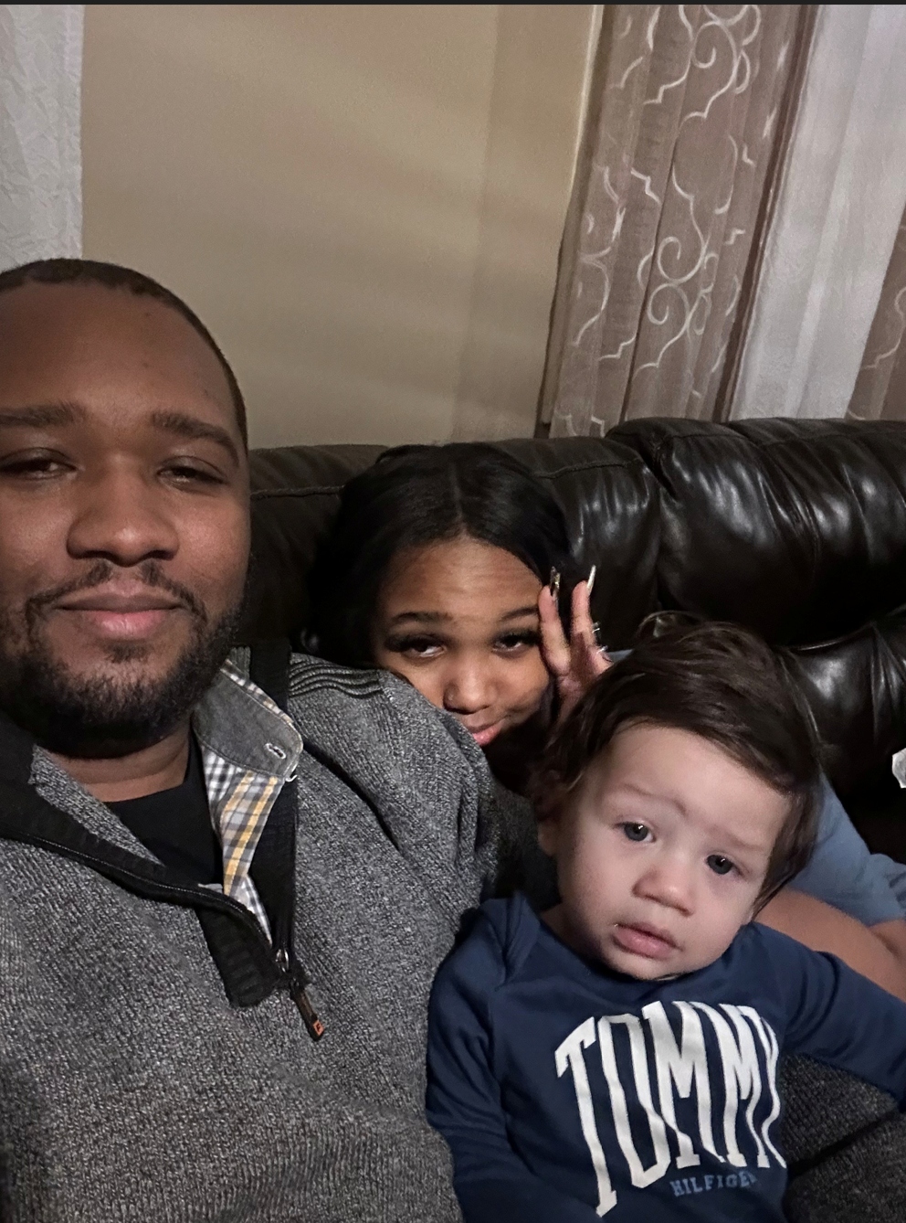Anthony with his daughter and youngest son on the couch.