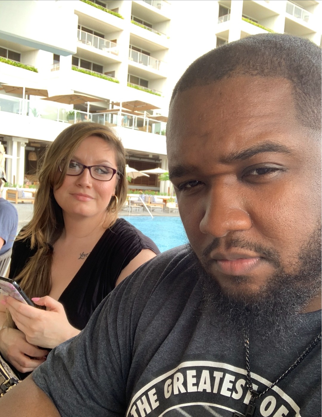 Anthony and his wife by a resort pool.